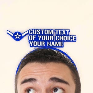 May include: A blue and white custom text design with the words "CUSTOM TEXT OF YOUR CHOICE YOUR NAME". The design includes a blue wing and star emblem. The design is on a white background.