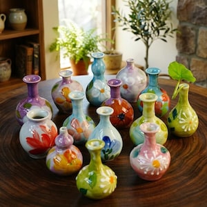 May include: A set of three ceramic mugs with a speckled, matte finish in cream, light grey, and dark grey. Each mug has a simple, minimalist design, ideal for coffee or tea.