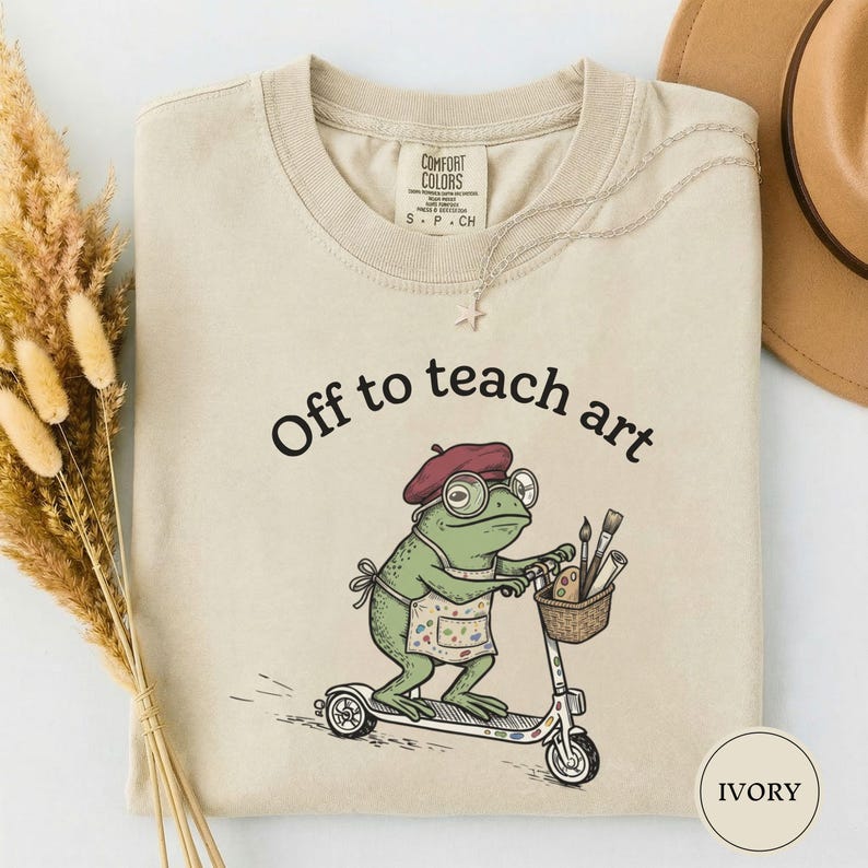 Off to Teach Art Shirt, Funny Frog Art Teacher Tee, Frog on Scooter Paint Gift, Women Art Educator Shirt, Frog Lover Tee, Funny Art Teacher Ivory