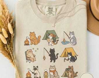 Camiseta fofa de gato acampando, camiseta aconchegante estilo campista, camiseta divertida para aventuras ao ar livre, presente para amantes da natureza que adoram trilhas com gatos.