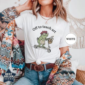 Off to Teach Art Shirt, Funny Frog Art Teacher Tee, Frog on Scooter Paint Gift, Women Art Educator Shirt, Frog Lover Tee, Funny Art Teacher White