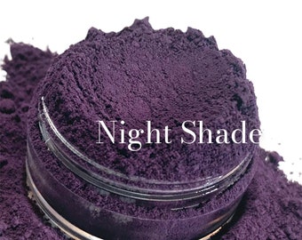 May include: A close-up of a small glass jar filled with a deep purple powder labeled "Night Shade".