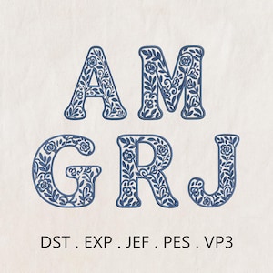 May include: Blue floral embroidered letters A, M, G, R, and J on a light background. The letters are filled with a detailed floral pattern. Below the letters are the file formats: DST, EXP, JEF, PES, and VP3.