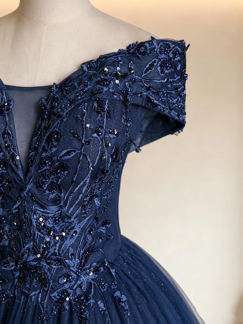 Magnificent front overview of a one size glittering navy blue starry night ballgown displayed in a serene studio showroom.