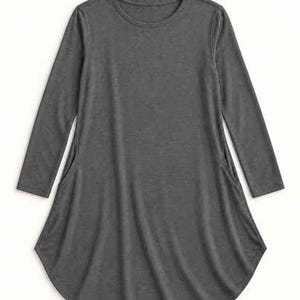 May include: A charcoal grey long-sleeve tunic top featuring a round neckline and a flared silhouette. The garment includes two side pockets integrated into the seams, with long sleeves and a curved hemline that extends slightly at the sides.