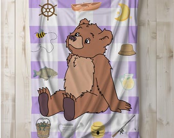 May include: A soft blanket featuring a light purple and white checkered pattern with a central brown bear illustration. Surrounding the bear are small icons including a ship wheel, a wooden boat, a yellow crescent moon, a bee, a fish, a bucket, a hat, a pitcher, a watering can, a beehive, and a fishing rod.