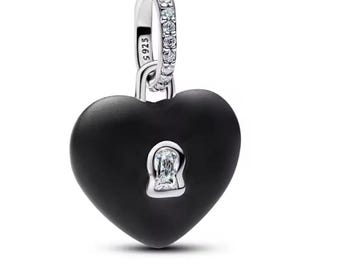 May include: A heart-shaped pendant with a matte black finish featuring a central keyhole cutout accented with a clear stone. The silver-toned bail is pavé-set with clear stones and is stamped with the text S925 on the side of the metal loop.