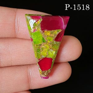 May include: A triangular-shaped gemstone cabochon featuring a mosaic pattern of vibrant magenta and bright lime green segments with metallic gold-colored inclusions. The surface is polished and smooth. The text P-1518 is visible in the top right corner.
