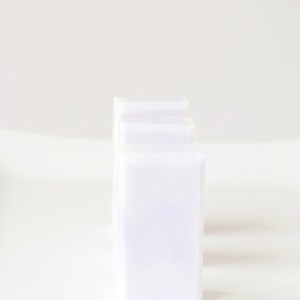 May include: Three white plastic storage containers stacked on top of each other.