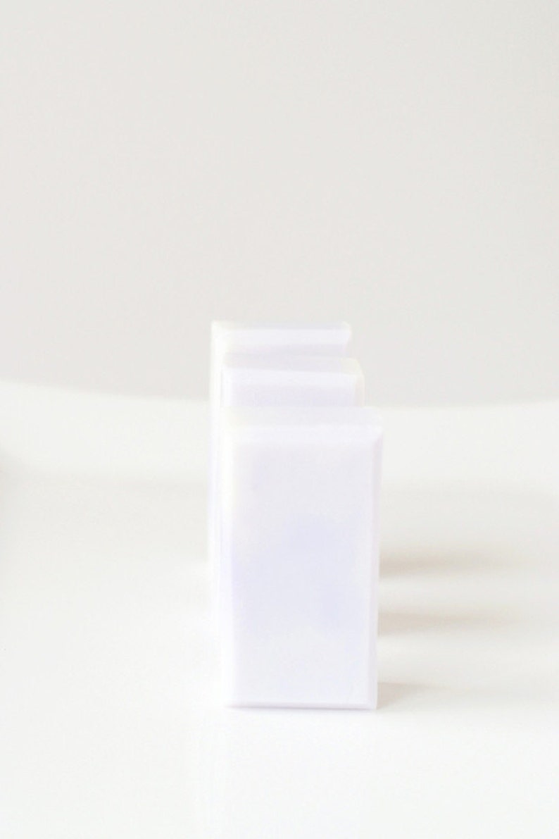 May include: Three white plastic storage containers stacked on top of each other.