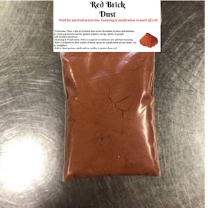 May include: A clear plastic bag filled with red brick dust. The bag has a white label with the text "Red Brick Dust" and instructions for spiritual protection and cleansing. A small image of the red dust is on the label.