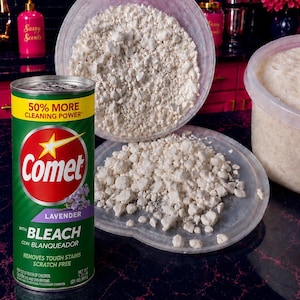 May include: A green cylindrical Comet cleaning powder container with a yellow top band reading 50% MORE CLEANING POWER, featuring a red logo, lavender graphics, and text stating WITH BLEACH. Beside it are two clear plastic lids filled with white powder.