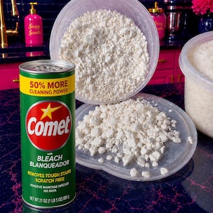 May include: A green cylindrical Comet cleaning powder container with a yellow band reading 50% MORE CLEANING POWER and a red circular logo with a yellow star. Next to it are two clear plastic lids filled with white, clumpy cleaning powder.