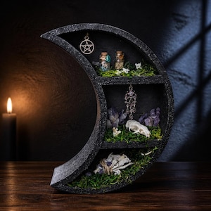 May include: A black crescent moon-shaped wooden shelf with three tiers. The shelves are decorated with green moss, small glass vials, a silver pentagram pendant, a hanging crystal ornament, purple amethyst clusters, and a small animal skull.