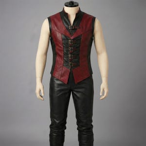 Front view of a red and black genuine leather vest with multiple front metal buckles and matching custom leather pants for fantasy themed cosplay and events.