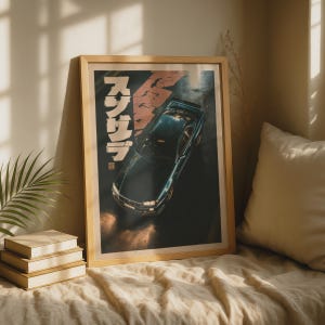 May include: A framed vertical wall art print featuring a dark blue sports car viewed from a high angle. The artwork includes white Japanese text characters on the left side and a red geometric shape, set against a dark, textured background.