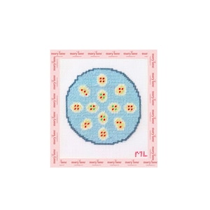 May include: A needlepoint canvas featuring a circular light blue motif with eleven small yellow and red floral-like patterns. The white grid canvas is bordered by a pink frame with the repeating text marylane and the initials ML in the corner.