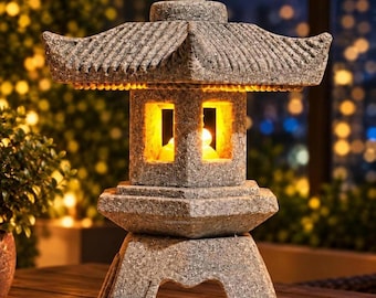 May include: A grey stone-textured lantern with a tiered roof and a square central chamber. The lantern features a warm, glowing light emanating from within the open windows. The structure stands on a wide, arched base with a rough, granular finish.