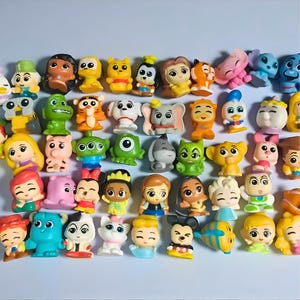 May include: A set of three ceramic mugs with a speckled, matte finish. The mugs are in shades of cream, light gray, and dark gray. Each mug has a simple, minimalist design, perfect for coffee or tea.