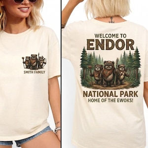 May include: A cream-coloured t-shirt with a family of Ewoks on the front and the text "Smith Family". The back of the shirt has the text "Welcome to Endor National Park, Home of the Ewoks!" with an Ewok illustration.