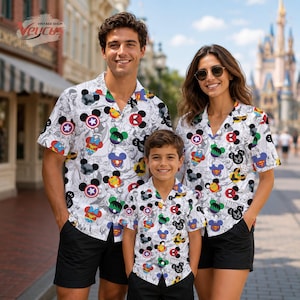 May include: Matching white button-down shirts with a colorful cartoon character print, worn with black shorts. The shirts feature a pattern of Mickey Mouse heads and superhero logos. The image includes the text "Veycus Vintage Shop".