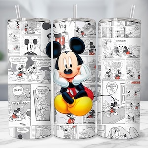 May include: A stainless steel tumbler featuring a comic strip design with Mickey Mouse. The tumbler has a clear straw and a wrap-around design with black and white panels and a central image of Mickey Mouse in color.