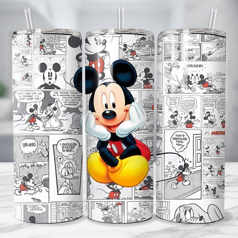 May include: A stainless steel tumbler featuring a comic strip design with Mickey Mouse. The tumbler has a clear straw and a wrap-around design with black and white panels and a central image of Mickey Mouse in color.