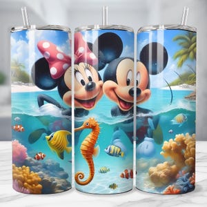 May include: A stainless steel tumbler featuring Mickey and Minnie Mouse in a tropical ocean scene. The design includes colorful coral, fish, and a seahorse. The background shows a blue sky, palm trees, and a sandy beach.