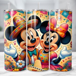 May include: A set of three stainless steel tumblers featuring Mickey and Minnie Mouse in festive Mexican attire. The design includes sombreros, colorful patterns, and musical notes against a yellow background. Each tumbler has a clear straw.