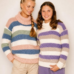 Può includere: Due donne indossano maglioni oversize a righe orizzontali. I maglioni hanno righe rosa, blu, verdi e bianche. I dolcevita aggiungono comfort. Lo stile è casual e comodo, perfetto per la stagione autunnale.