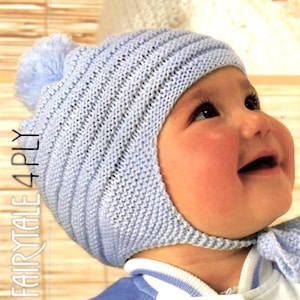 May include: A light blue knitted baby hat featuring a ribbed texture, ear flaps, and a matching pom-pom on top. The text "FAIRYTALE 4PLY" is printed vertically along the left side of the image in a clear, sans-serif white font.