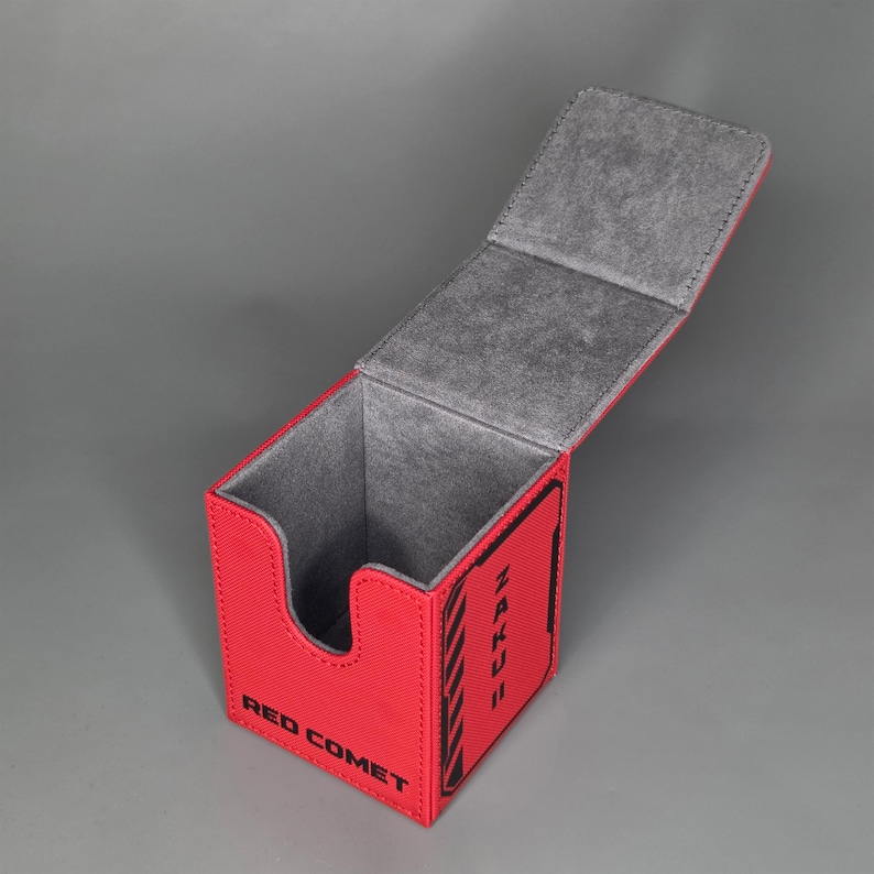 Open red TCG deck box showing soft interior lining and card storage compartment for standard size trading cards