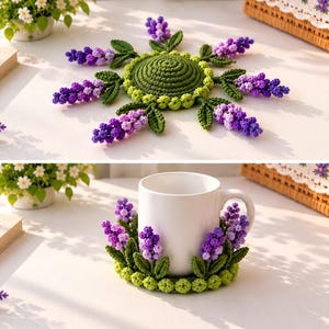 May include: A round, green crocheted coaster featuring a central circular base surrounded by six radiating sprigs of purple and lavender flowers with green leaves. The coaster is shown flat and also wrapped around a white ceramic mug.