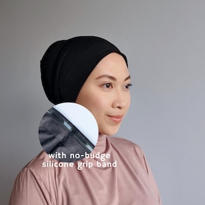 May include: A black head covering with a no-budge silicone grip band. The head covering is worn by a person. The text "with no-budge silicone grip band" is visible in the image.