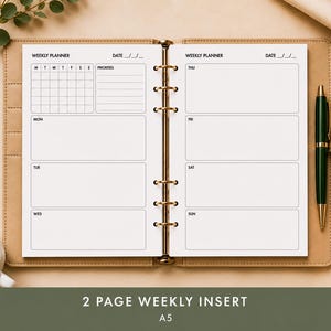 May include: Open planner with a weekly layout, featuring sections for each day, a priorities list, and a calendar grid. A green pen rests on the right side. The planner is open to a two-page spread, with the text "2 PAGE WEEKLY INSERT" and "A5" at the bottom.