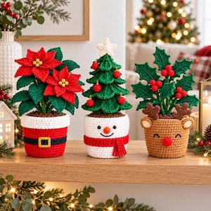 May include: Three crocheted holiday plants in decorative pots. The left is a red poinsettia in a Santa-themed pot. The center is a green Christmas tree with red ornaments in a snowman pot. The right is a holly plant in a reindeer pot.