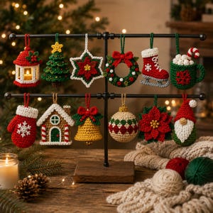 May include: A collection of twelve crocheted Christmas ornaments hanging on a black metal display stand. The ornaments include a lantern, tree, star, wreath, ice skate, mug, mitten, house, bell, ball, poinsettia, and gnome in red, green, and white.