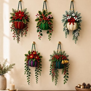 May include: Five hanging wall decorations featuring knitted pumpkins in red, green, white, purple, and dark teal. Each pumpkin is adorned with artificial greenery, red berries, and festive accents like poinsettias, candy canes, and small bells.