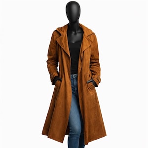 May include: A long, brown trench coat with a wide collar and pockets. The coat is displayed on a mannequin, showcasing its flowing design. The coat is made of a soft, textured material and has a classic, timeless style.