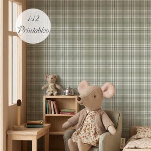 Könnte beinhalten: Ein 1:12 Puppenstuben-Zimmer mit salbeigrünem Karotapeten-Muster, einem Holztisch, einem Bücherregal, einem kleinen Bett und einer Stoffmaus in einem geblümten Kleid und beiger Strickjacke, die in einem grauen Sessel sitzt.