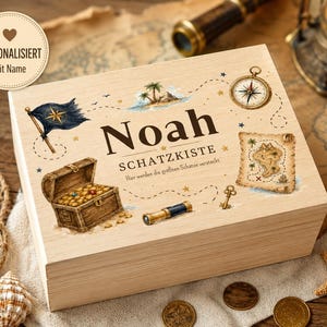 Könnte beinhalten: Eine rechteckige Holzkiste mit einem aufgedruckten Piraten-Motiv, dem Namen Noah, dem Text SCHATZKISTE und dem Satz Hier werden die größten Schätze versteckt. Abgebildet sind eine Schatztruhe, ein Kompass, eine Landkarte und eine Flagge.