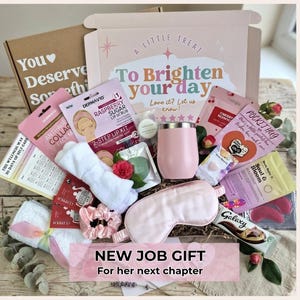 May include: A self-care gift box containing a pink insulated tumbler, a light pink sleep mask, a white headband, a pink scrunchie, a raspberry lip scrub kit, a chocolate bar, and various skincare packets. The box lid reads A Little Treat To Brighten your day.