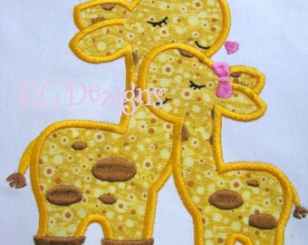 May include: Embroidered patch of two yellow giraffes with brown spots, the larger giraffe is kissing the smaller giraffe on the head.