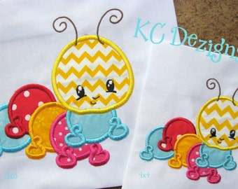 May include: Embroidered design of a yellow and white chevron patterned caterpillar with a blue body and red, yellow, and pink polka dot segments. The design is available in two sizes, 4x4 and 6x6 inches.