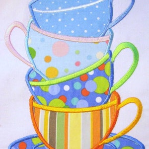 May include: A stack of four colorful teacups with polka dot and striped patterns. The teacups are stacked on a blue saucer with green and red polka dots.