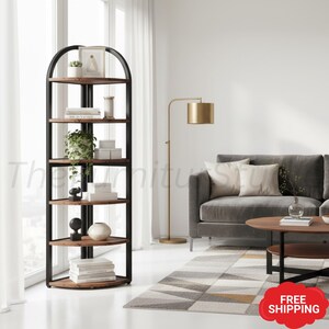 May include: A tall, corner-style bookshelf featuring a black metal frame with an arched top and five triangular wooden shelves. The unit is designed to fit into a corner, providing multiple levels for storage and display of books and decor.