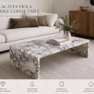 May include: A rectangular Calacatta Viola marble coffee table with a white and purple veined pattern. The table is handmade and has a timeless design. The text "CALACATTA VIOLA MARBLE COFFEE TABLE" is at the top of the image.