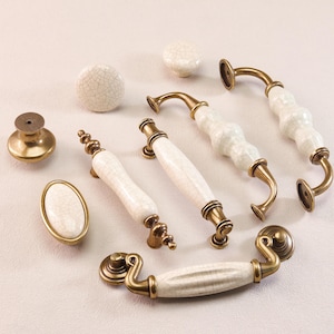 May include: A white ceramic mug with a black handle and the text "But First, Coffee" in a handwritten style. The mug is on a white surface. The mug is 10 cm tall.