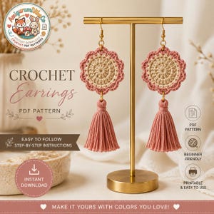 Puede incluir: Un par de pendientes de ganchillo con diseño floral y borlas rosas, expuestos en un soporte dorado. Los pendientes tienen un centro beige y un borde rosa. El texto "CROCHET Earrings PDF PATTERN" es visible.