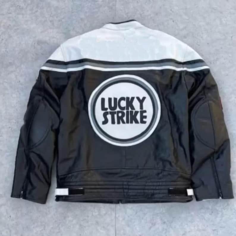 May include: Black and white leather jacket with a white upper back panel and the text "LUCKY STRIKE" in a circular design on the back. The jacket has black sleeves and a white stripe detail across the back.